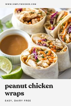 some chicken wraps on a plate with dipping sauce