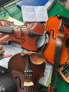 an assortment of violin's and musical instruments on display