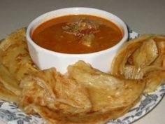 a bowl of soup and some food on a plate