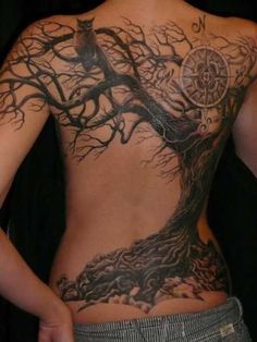 a woman with a tree tattoo on her back