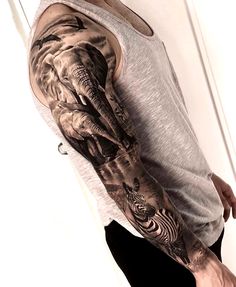 a man's arm with an elephant and zebra tattoo on it