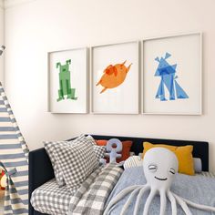 an octopus stuffed animal sitting on top of a bed next to pillows and pictures hanging on the wall