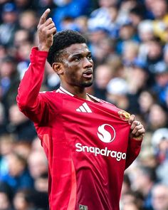 a soccer player holding his hand up in the air