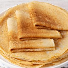 a stack of pancakes sitting on top of a white plate