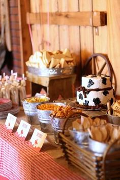 a table topped with lots of different types of foods and desserts next to each other