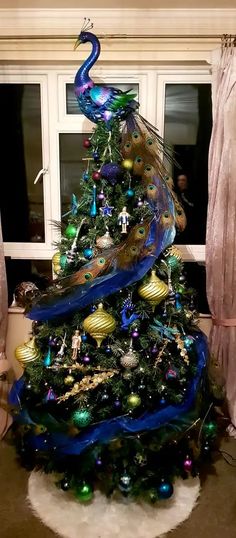 a christmas tree decorated with peacocks and ornaments