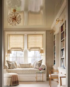 a living room filled with furniture and windows