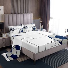 a bed with soccer themed sheets and pillows