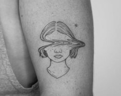 a woman with a hat on her head is shown in black and white tattoo art