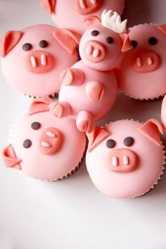 cupcakes made to look like pigs with horns on their heads and noses, all in pink frosting