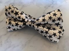 Upgrade your wardrobe in style with this stunning white bow tie featuring a unique black star pattern. Perfect gift for him, this adjustable bow tie will elevate your style for any occasion including weddings, birthdays and anniversaries. Comes pre-tied. White Bow Tie For Black-tie Events, White Bow Tie For Black Tie Events, White Adjustable Bow Tie For Black Tie Occasions, Adjustable White Bow For Black Tie Occasion, White Bow Tie, Burgundy Floral, Perfect Gift For Him, White Bow, Star Pattern