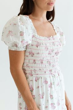 The Julia Dress is just dreamy and sweet! Made of 100% cotton, this dress features a smocked bodice that offers a flattering fit and an easy, flowy silhouette. With its sweet floral print, ruffle details, and full lining, its not only adorable but comfortable making it a go-to dress for a breezy, chic look. Hamptons Collection FIT Easy True To Size Fit Smocked Bodice Lined Bridget is 5'9 Wearing Size Small SMALL MEDIUM LARGE 54" Long 55" Long 56" Long 12" Wide 13" Wide 14" Wide For more sizing i Lulusar Dresses, Church Fits, Dress Book, She Is Clothed, Julia Dress, Floral Outfit, Large Dress, Church Outfits, Chic Look