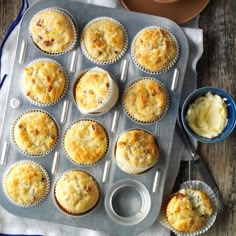 a muffin tin filled with lots of different types of cupcakes and butter