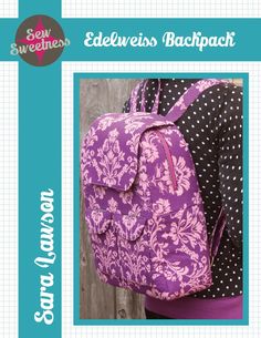 the back side of a purple backpack with white flowers on it, and polka dots