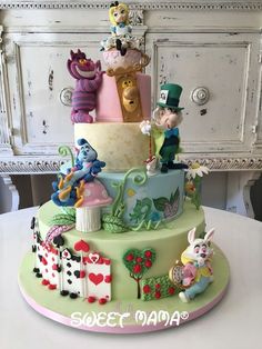 a multi layer cake decorated with cartoon characters