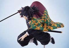 a figurine is posed on top of a pole with a stick in his hand