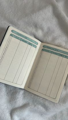 an open notebook sitting on top of a bed