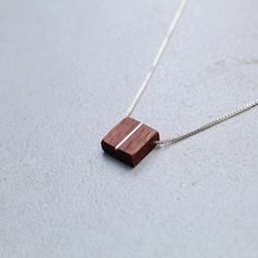 This handcrafted dainty square walnut pendant is made with a silver inlay paired with an adjustable sterling silver threader chain(16-22in) perfect for any style you choose to wear it with. Brown Square Pendant Jewelry For Gift, Minimalist Adjustable Rectangular Necklace, Adjustable Sterling Silver Necklace With Square Pendant, Minimalist Brown Necklace For Gift, Minimalist Brown Necklace For Gifts, Minimalist Brown Sterling Silver Jewelry, Minimalist Brown Necklaces For Gifts, Brown Rectangular Pendant Necklace As Gift, Adjustable Rectangular Sterling Silver Necklace