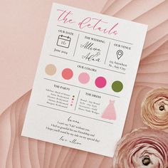 a wedding program on top of a pink flower next to it's paper flowers