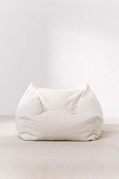 a white bean bag chair sitting on top of a floor