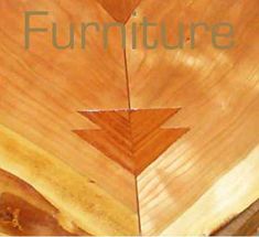 a wooden table with the words furniture on it and an arrow in front of it