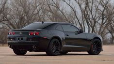 a black chevrolet camaro parked in a parking lot