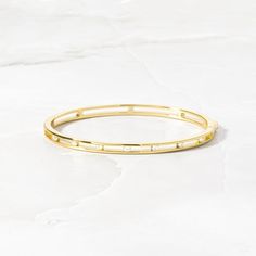 Everyday Diamond Accents Bangle, Everyday Gold Jewelry With Channel Set, Everyday Bangle With Diamond Accents, Everyday Gold Channel Set Jewelry, Modern Everyday Bangle With Diamond Accents, Stackable Yellow Gold Bangle With Cubic Zirconia, Minimalist Gold Bangle With Single Cut Diamonds, Gold Minimalist Bangle With Single Cut Diamonds, Channel Set Bangle Bracelets As Gift