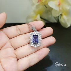 "Large Tanzanite Jewelry Rectangular Royal Flower Style Unique Artisan design Full Sterling Silver Made Luxury Gemstone Jewelry ◆◆Pendant Main stone:10*14mm Created Tanzanite 10CT Pendant Height ( include bail) : 30.9mm Pendant Holder (bezel & Bail) : White Gold Coated fine 925 Sterling Silver Accent Stone: Sim Diamond ◆◆ Necklace chain : Platinum gold coated 925 sterling silver Chain with length option from 16\" ~ 20\". The model wearing 18\". 16 inch ≈ 40cm 18 inch ≈ 45cm （Most popular siz Elegant Hallmarked Rectangular Pendant Jewelry, Luxury Silver Tanzanite Necklace, Elegant Sapphire Necklace With Emerald Cut, Luxury Tanzanite Necklace For Anniversary, Luxury Tanzanite Necklaces For Anniversary, Sapphire Gemstone Necklace In Rectangular Shape, Sapphire Gemstone Rectangular Necklace, Rectangular Sapphire Gemstone Necklace, Formal Sapphire Necklace With Rectangular Shape