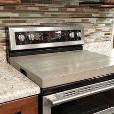 a stove top oven sitting inside of a kitchen