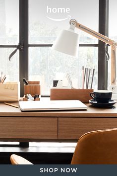 an office desk with a lamp on it and the words, home shop now above it