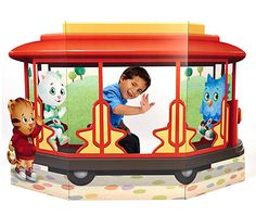 a young boy riding on the back of a toy train with cats and kittens