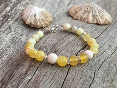 yellow agate bracelet | gemstone bracelet | yellow bracelet | white lava bracelet | summer bracelet | genuine lava | zirconia | white and yellow | elegant bracelet | luxury bracelet This is not just another beaded bracelet.  This lovely bracelet is made of highest quality, natural white lava beads and yellow agate. Decorated with some beautifully sparkling zirconia spacers. The yellow agate beads are faceted, which means they are cut and polished many times in a way to obtain multiple surfaces o White Agate Gemstone Bracelets, Yellow Natural Stones Beaded Bracelet, Yellow Spiritual Bracelet With Gemstone, Yellow Spiritual Gemstone Bracelets, Yellow Spiritual Gemstone Bracelet, Yin Yang Balance, Yellow Agate, Bracelet Luxury, Bracelet Summer