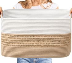 a woman holding a large white and beige basket