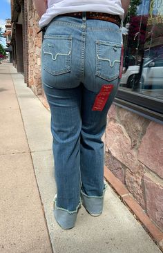 A high-rise stovepipe jean with a wide leg and raw hem, the Olivia is the perfect everyday jean. Made from tri-blend denim for maximum wearability and rebound, this lightweight jean is accented with the iconic Longhorn logo on both back pockets.Fabric: 82% Cotton | 15% Polyester | 3% ElastaineFit: High Rise, Stove Top, Wide Leg with a Raw HemDetails: Hand sanding on light wash denim with whisker detailConstruction: 11.5 Oz. DenimKimes jeans have the longevity and durability because they use sour 7s Jeans, Kimes Jeans, Wide Leg Jeans Outfit, Artisan Jewelry Necklaces, My Shopping List, Chain Top, Graphic Tops, Jeans Outfit, Jogger Jeans