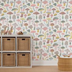 the wallpaper in this room is very colorful and has mushrooms on it, as well as wicker baskets