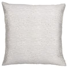 a white pillow with sequins on it