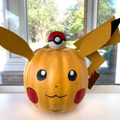 a pumpkin shaped like a pikachu sitting on top of a table