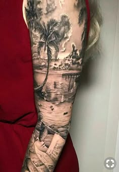 a woman's arm with a palm tree and water scene tattoo on her left arm