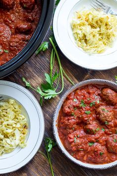 several plates of food on a table with pasta, meatballs and noodles in them