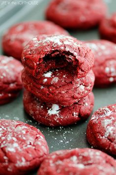 red velvet cookies with powdered sugar in the middle on a baking sheet, ready to be eaten