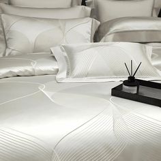 a white bed topped with lots of pillows