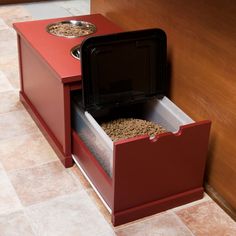 a red dog food drawer with two bowls in it