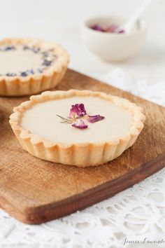 two pies on a cutting board with flowers in the middle and one is empty