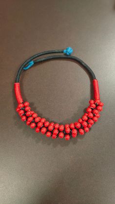 Beautiful excellent quality choker necklace with many red beads together. About four inches in diameter. Handmade. Comes in good quality bag with handwoven intricate gold design. Gift Red Handwoven Beaded Necklaces, Red Handwoven Necklace For Gift, Unique Red Handwoven Necklace, Red Fair Trade Beaded Necklace As Gift, Artisan Red Beaded Necklaces Handwoven, Artisan Red Handwoven Beaded Necklaces, Red Handwoven Necklace, Handwoven Red Necklace, Handmade Red Beaded Necklaces For Festivals