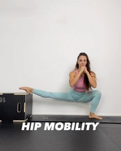 a woman is doing yoga in front of a box