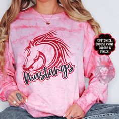 Show off with this custom and personalized Mustangs mascot design. These shirts and sweaters are great gifts for school teams, camp spirit wear, Mustangs coaches, Mustangs teachers, Mustangs Moms, Dads, girlfriends, and the whole family! You can customize the colors in the personalization section to reflect your favorite Mustangs team. It is trendy to size up 2 sizes for an oversized look or size down for a tighter fit.  To add a name (and or number) to the back of a shirt, add lounge pants, expedite processing, add overnight shipping, and any other miscellaneous items- please follow this link: https://www.etsy.com/shop/KASPDesign?ref=seller-platform-mcnav§ion_id=27547745 The listing is for one garment. To order... 1. Select the style and size you would like, then the color for the garment School Spirit Sublimation Crew Neck For Sports Season, College Fan Apparel With Team-colored Sublimation Design, College Sports Fan Sublimation Design, Varsity Sublimation Print Design For College, Game Day School Spirit Sublimation Crew Neck, Custom Print Sweatshirt For Game Day With Team Spirit, Customizable Team-colored Sublimation Design For School Spirit, Fan Apparel Sweatshirt With Custom Print For Sports Events, Team-colored Sweatshirt For School Spirit