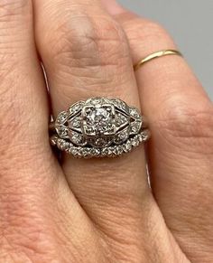 a close up of a person's hand with a wedding ring on their finger