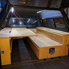 the inside of a vehicle with a table and bench