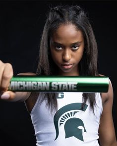 a woman holding up a michigan state pencil