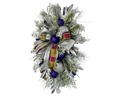 a christmas wreath with silver and purple decorations